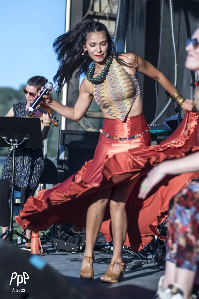 Mamselle Ruiz danse en jupe rouge sur une scène extérieure